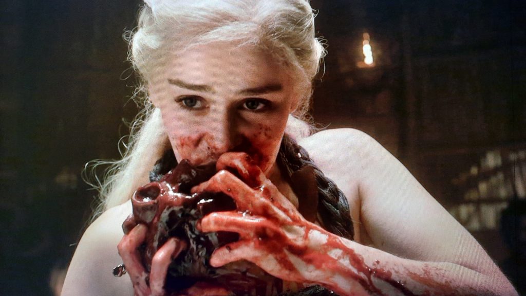 Daenerys Targaryen eating a horse's heart.